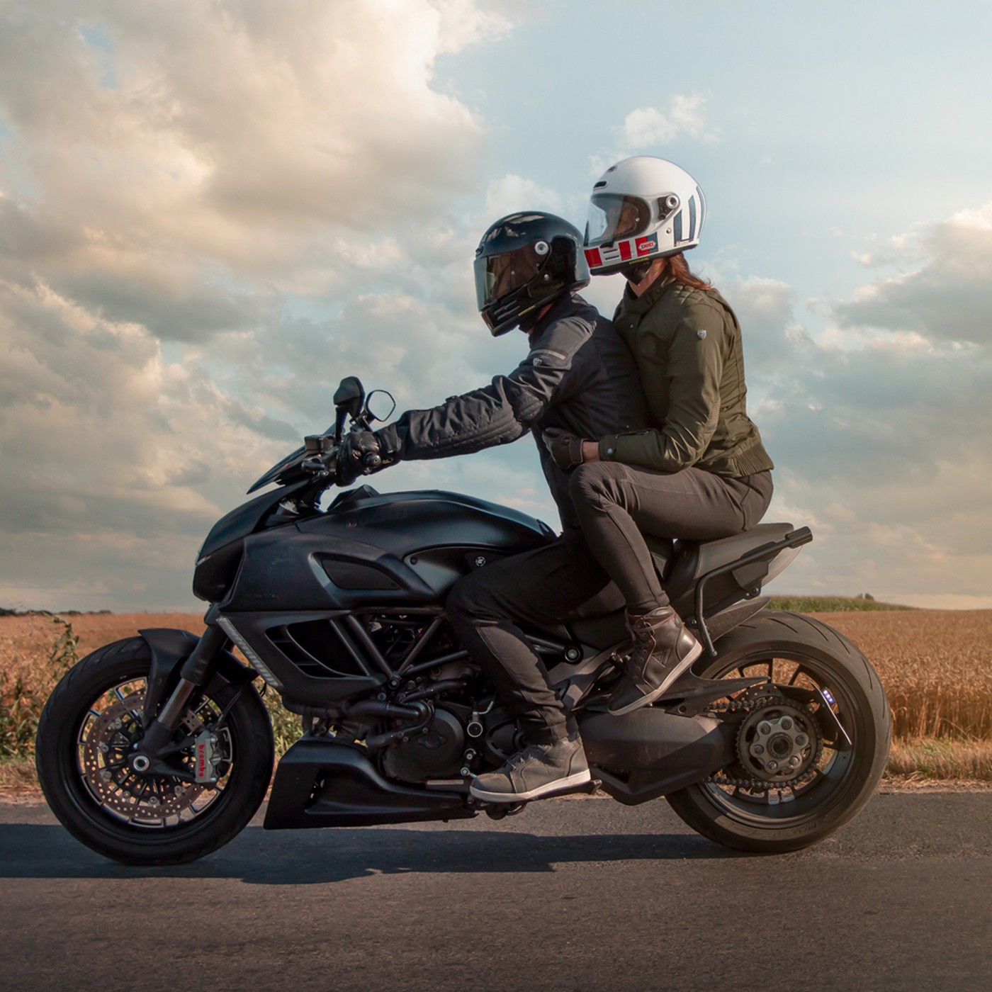 A motorcyclist and a female motorcyclist out for a ride in the countryside