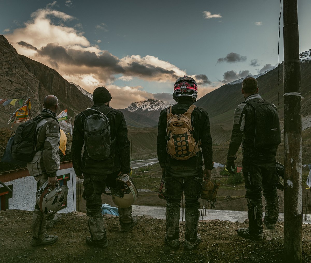 A motorcyclist in the mountains, looking down into the valley
