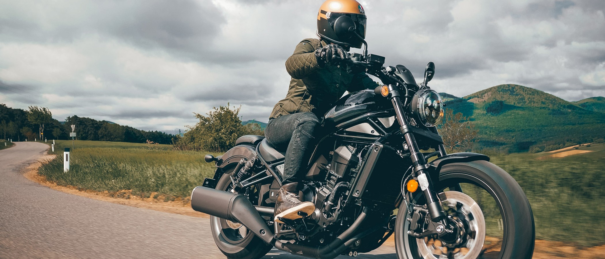 A motorcyclist riding along the road